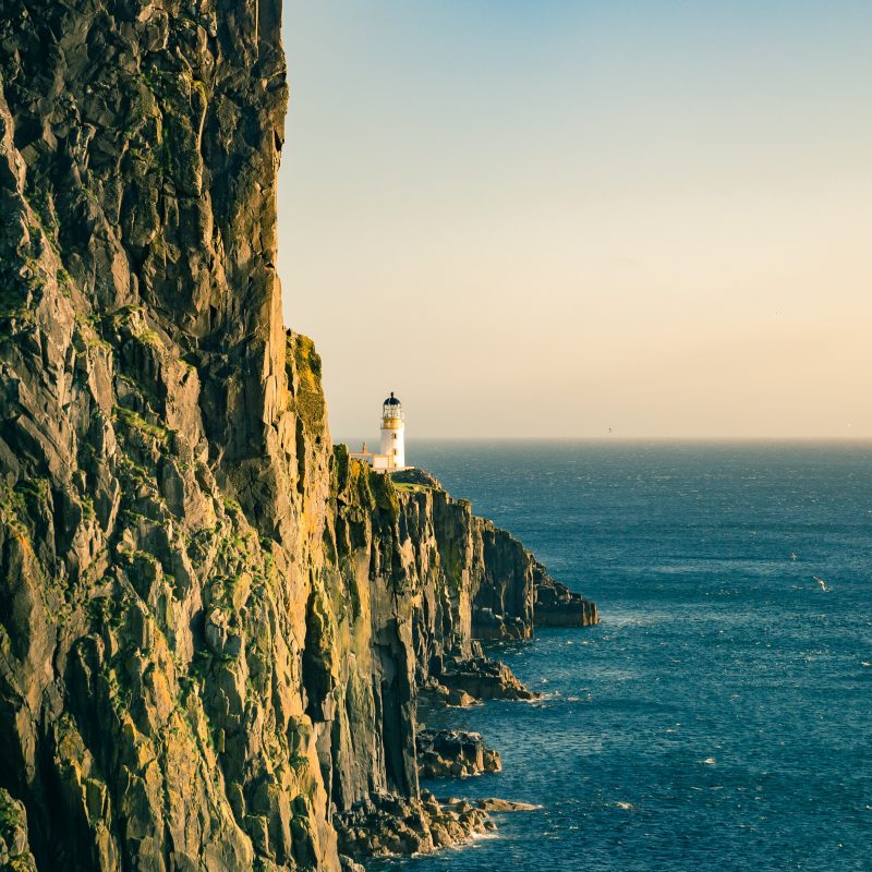 scottish lighthouse on a cliff in the sea